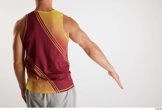 Darren  1 arm back view dressed flexing red-yellow tank…